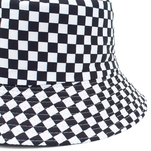 Close-up of checkerboard pattern and stitching detail on a black and white bucket hat