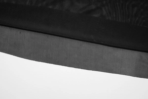 Close-up of the black mesh fabric detail and fine stitching on this two-piece skirt set