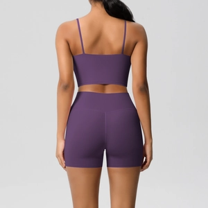 Detail of cross-back thin straps on a purple yoga sports bra and high-waist shorts set