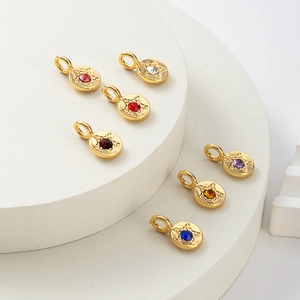 Macro view of seven round gold pendants with colorful stones and star engravings