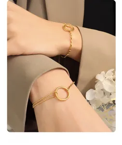 Detailed close-up of a minimalist 18K gold-plated double-layer chain bracelet with a ring