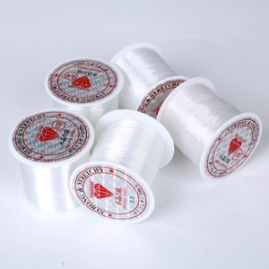 Stack of clear crystal string rolls in 0.25mm to 0.5mm sizes for DIY jewelry making