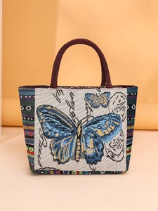 Retro woven tote bag with blue butterfly embroidery and brown fabric handles for women