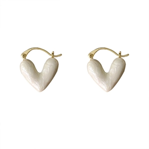 Elegant cream heart earrings with gold clasp set against a clean white background