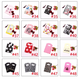 Selection of 16 mini plastic gift bags with patterns like flamingos and leopard print