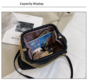 Spacious interior of black quilted evening bag showing capacity for tablet and cosmetics