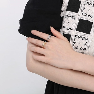 Detail of elegant gold and silver pearl rings with crystals worn by a model