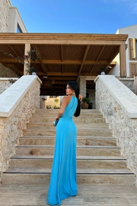 Detail of blue backless maxi dress showing smooth draped fabric on stone stairs