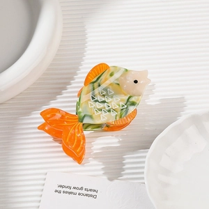 Creative tropical fish acetate hair claw clip with orange and green marbled texture patterns