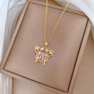 Luxurious gold butterfly necklace with pink gemstone and sparkling zircon crystals