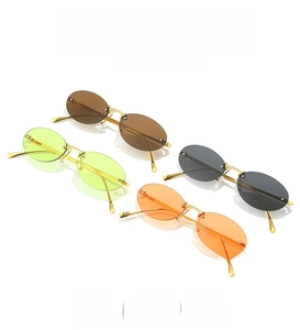 Detail view of oval rimless Y2K sunglasses in four colors with gold metal frames