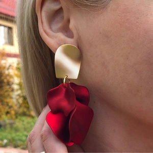 Elegant rose petal earrings with matte gold studs and layered red 3D petals on model
