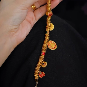 Detail of 24k gold-plated bangle with enamel charms and traditional Chinese characters