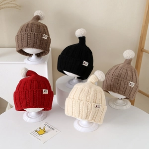 Toddler ribbed knit beanie with white pompom in various colors like red and beige