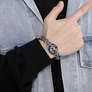 Close-up of vintage steel lion head bracelet on wrist with detailed relief and chunky chain