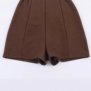 Women's brown shorts with bow detail featuring tailored seam and folded hem