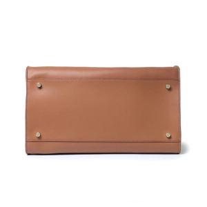 Bottom view of brown leather tote bag with silver protective metal studs and stitching