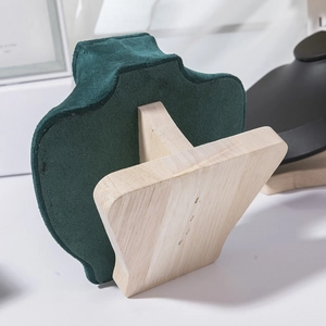Detail of emerald green suede necklace display stand with premium solid wood base support