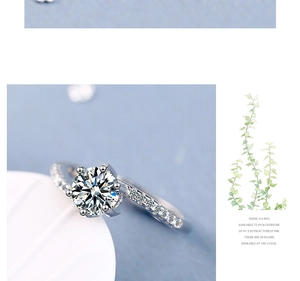 Macro detail of six-prong round cut diamond ring with pavé setting on wide band