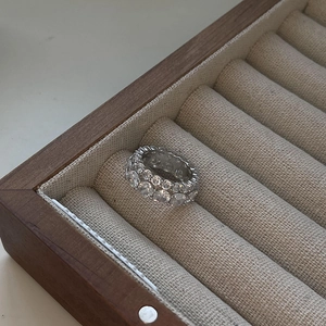 Elegant S925 sterling silver double row pavé zircon ring displayed on a wooden jewelry box