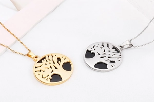 Detail view of gold and silver tree of life pendants with hollow circular design