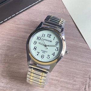 Macro detail of elastic stainless steel watch band and quartz dial with clear numerals