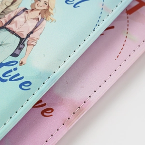 Detail of UV printed passport covers in pink and blue with premium PU leather texture