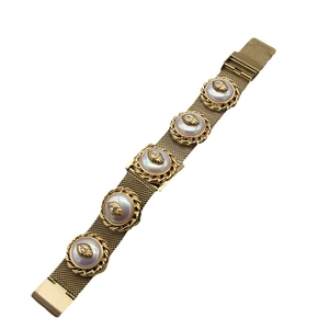 Vintage gold mesh bracelet with five round pearl-style accents and heart relief
