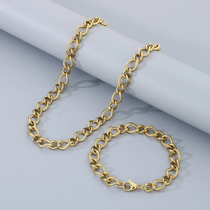 Detailed shot of golden stainless steel necklace and bracelet set with lobster clasp