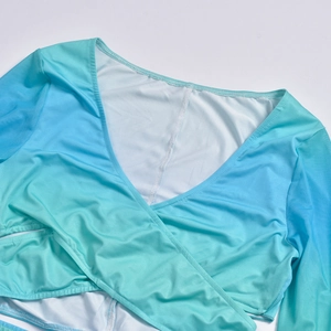 Detail of cross-front deep V-neck crop top with blue and green gradient knit texture