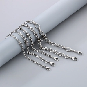 Close-up of vintage stainless steel barbed wire bracelets with diverse chain textures