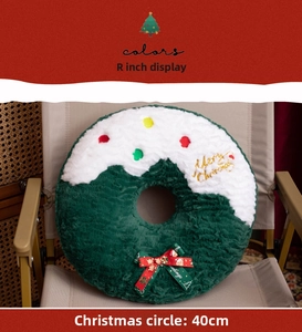 Close-up of 40cm green plush Christmas wreath cushion with Merry Christmas embroidery