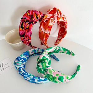 Detail of colorful knotted headbands with vibrant abstract patterns in various hues