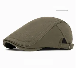 Detail of army green cotton flat cap with adjustable metal buckle on textured fabric