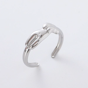 Macro shot of silver adjustable open ring with abstract minimalist design on white backdrop
