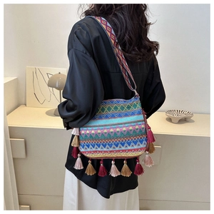 Ethnic style crossbody bag featuring colorful woven patterns and vibrant fringe tassels