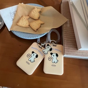 Detail of dog pattern silicone card holders with spring hooks on a wooden table