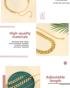 Detail of adjustable gold alloy chain belt with lobster clasp and metal ball pendant