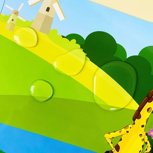 Close-up showing the waterproof material of children's sticker book with water droplets