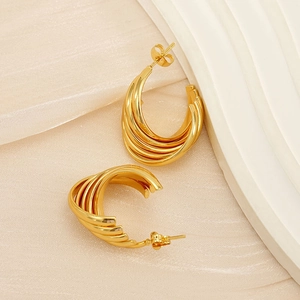 Macro shot of 18K gold plated multi-layered intertwined chunky hoop earrings for women