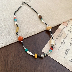 Detail of vintage necklace with colorful stone resin beads and wooden geometric charms