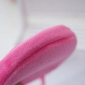 Detailed macro view of high-quality pink plush fabric texture and clean edge stitching