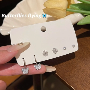 Detail of S925 silver needle butterfly and flower earring set with zircon accents