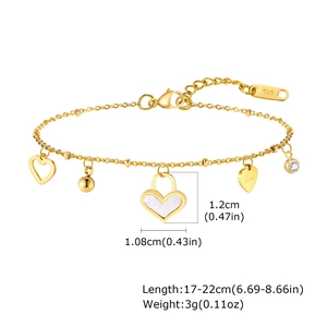 Macro shot of gold stainless steel bracelet with shell heart charm and K18 tag details