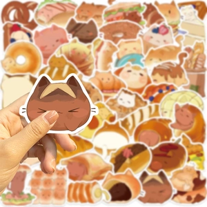 Close-up of cute cartoon cat stickers with bread motifs on guitars and laptops