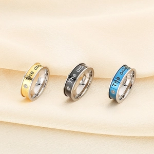 Three-color stainless steel rings with The Only engraving and a single inset diamond