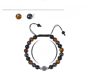 Detail of tiger eye and hematite beaded bracelet with compass charm and 8mm beads