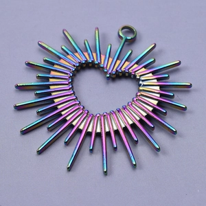 Macro detail of rainbow heart sunburst charm in 304 stainless steel for DIY jewelry