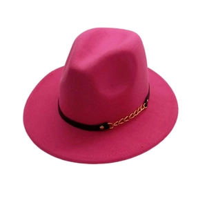 Detail of rose red fedora hat featuring black leather band and gold metal chain link