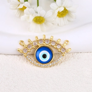 Detailed view of gold-plated evil eye charm with blue enamel and sparkling zircon accents